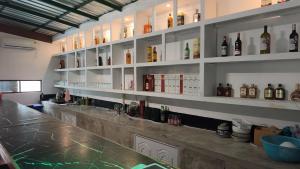 a bar with lots of bottles of alcohol at บ้านสวนร่มไม้แอ๊ดเชียงดาว in Ban Hua Thung