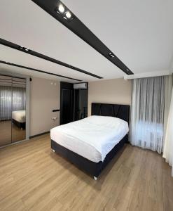 a bedroom with a large white bed in a room at Riviera Villa Kemer in Agva
