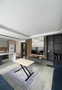 a living room with a table and a kitchen at Riviera Villa Kemer in Agva