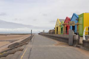 a row of colorful buildings on the beach at 6 Bastion Close in Prestatyn