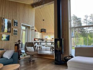 a living room with a couch and a tv and a table at Exclusive Designer Cabin - Panoramic Mountain View in Vossevangen +33 photos