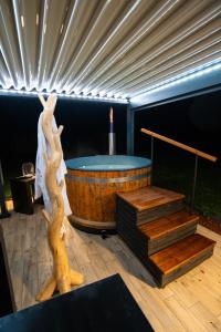 a room with a hot tub and a table with a candle at GITE L'ECRIN Pays de Caux in Bosc Renoult