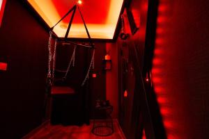 a red room with a staircase with a red light at GITE L'ECRIN Pays de Caux in Bosc Renoult