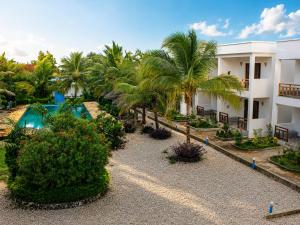 an aerial view of a resort with a swimming pool and palm trees at Jabali Bungalows Lodge in Paje