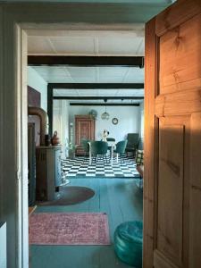 a view of a living room with a table and chairs at Autentisk Gård Tæt På Vandet På Samsø in Ballen