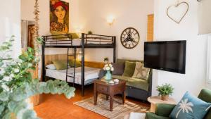 a living room with bunk beds and a couch at Cala Canyelles Villa & Private Studio with Garden in Lloret de Mar