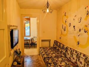 a living room with a couch and a tv at The Re-Born Hostel in Timişoara
