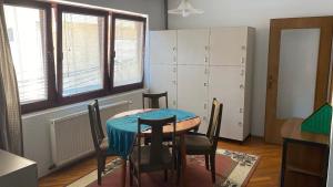 a dining room with a table and chairs in a room at Kardelen Hostel in Prishtinë