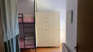 a bedroom with a bunk bed and a mirror at Kardelen Hostel in Prishtinë