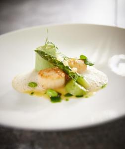 a white plate with a piece of food on it at Hotel Nassauer Hof in Limburg an der Lahn