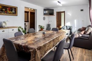 a dining room with a table and chairs at CASA CODRILOR - Greencodru liniste si relaxare in Codru