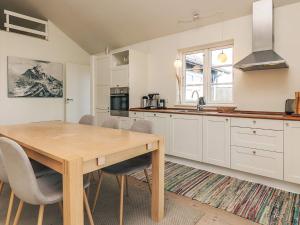 a kitchen with a wooden table and a dining room at 5 star holiday home in Nysted in Nysted