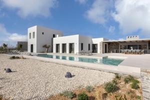 a house on the beach with a swimming pool at Celestial Villas in Santa Maria