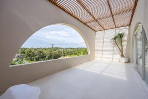 an arched window in a white room with a view at 2BR Pool Villa Bingin w Ocean View Rooftop - Tasanaa in Badung