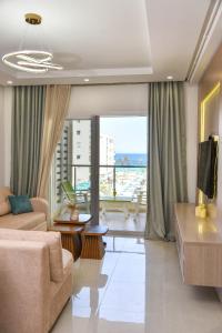 a living room with a couch and a large window at L'escapade in Sousse