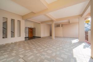 an empty room with a door in a building at Itsy Hotels Snowdrop in Coimbatore