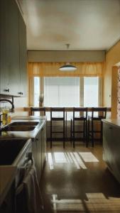 a kitchen with a sink and a table with chairs at Villa Astrid in Pietarsaari