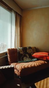 a living room with a couch and a window at Villa Astrid in Pietarsaari +8 photos