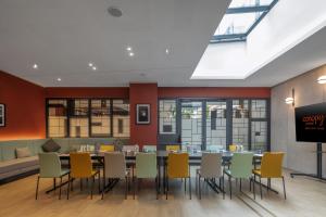 a dining room with a table and chairs at Canopy By Hilton Paris Eiffel Tower in Paris
