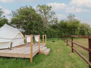a tent sitting on a wooden deck in a field at Bell 3 in Cirencester