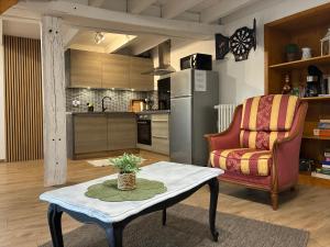 a living room with a table and a chair at Gîte Therence chez Bruno in Sainte-Thérence