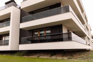 an apartment building with a large balcony at GOLDEN HAUS Opole - Royal Blue & Royal Green in Opole