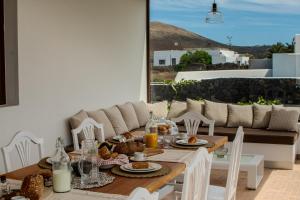 a dining room with a table with food on it at Villa Barrilla by Villalize in Tinajo