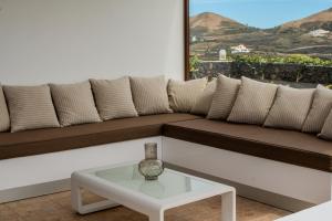 a living room with a couch and a table at Villa Barrilla by Villalize in Tinajo