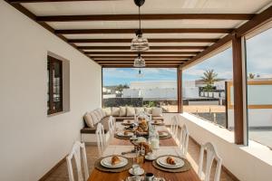 a dining room with a table and chairs at Villa Barrilla by Villalize in Tinajo