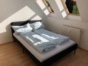 a bed with blue blankets and pillows on it at Urban Worker Flat in Kirchberg