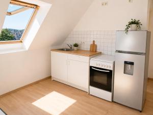 a kitchen with a white refrigerator and a sink at Urban Worker Flat in Kirchberg