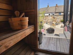 a door to a patio with a view of a yard at 3 Waters Spa - Private Spa with Jacuzzi, Sauna & Hammam in Winenne