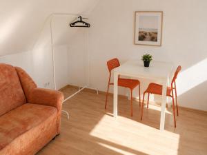 a living room with a table and chairs and a couch at Urban Worker Flat in Kirchberg