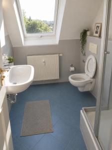 a bathroom with a sink and a toilet and a window at Urban Worker Flat in Kirchberg