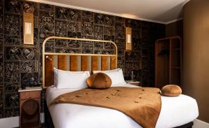a bedroom with a bed with black and white wallpaper at Hôtel BOHEM, Sacré-Cœur in Paris