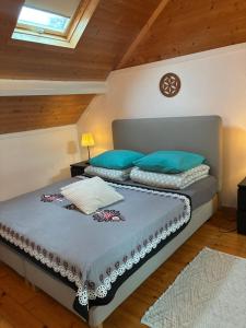 a bedroom with two beds with blue pillows at Gîte au Bon Accueil Therence in Sainte-Thérence