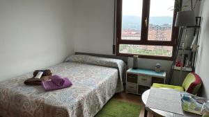 a bedroom with a bed with a purse on it at GAIA Hab doble con baño compartido in Bilbao