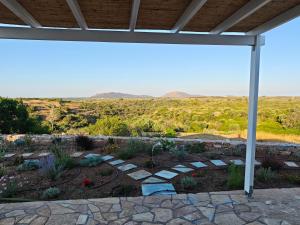 a garden under a pergola with a view of the desert at Kastri 2 in Kythira