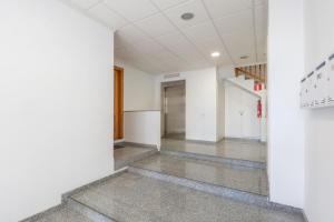 an empty hallway of an office building with a staircase at ELS BALADRES in Deltebre
