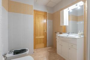 a bathroom with a sink and a toilet and a mirror at ELS BALADRES in Deltebre +11 photos