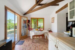 a kitchen with a table in the middle of it at Villa Esperance in Grand Brassac