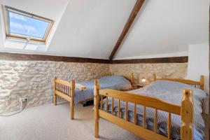 a attic bedroom with two beds and a window at Villa Esperance in Grand Brassac +33 photos