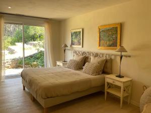 a bedroom with a large bed and a window at L'Irisciabella in Lourmarin +62 photos