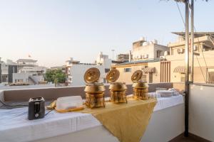 a table with three trophies on top of a roof at Treebo Hub in Indore
