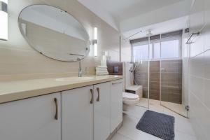 a bathroom with a sink and a mirror and a toilet at Spacious Luxury Beach Getaway by Torohome in Ashdod +34 photos