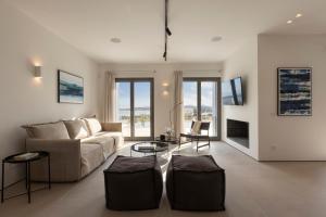 a living room with a couch and a table at Celestial Villas in Santa Maria