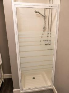 a shower with a glass door in a bathroom at The Anglers Inn in Guildtown