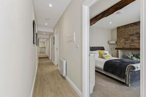 a bedroom with a bed and a brick wall at Chic City Apartment in Wakefield