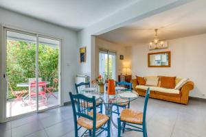 a living room with a table and chairs and a couch at Gîte Gignac Vallée De L'hérault in Gignac