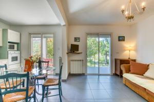 a dining room and living room with a table and chairs at Gîte Gignac Vallée De L'hérault in Gignac
